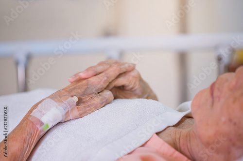 medicine, age, health care and people concept - older woman patient lying in bed at hospital ward.