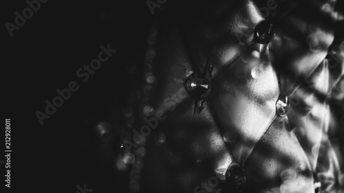 Diamonds are attached to the leather of the sofa. Close-up photography