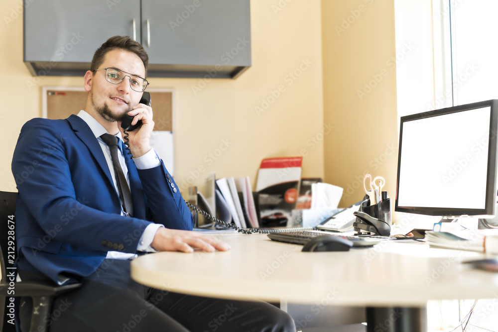 Business man working at a car dealer smiling