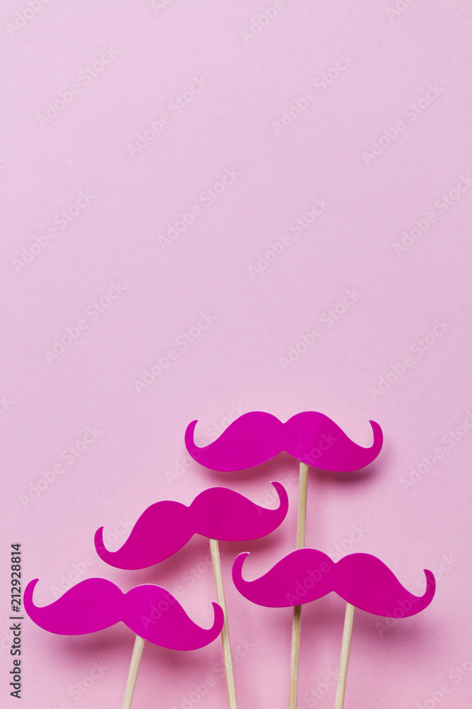 Pink moustache on a pink background. Modern masculinity concept