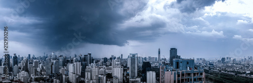 rain clouds over city  panoramic aerial cityscape  residential buildings and business skyscraper