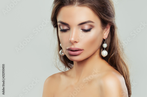Woman with perfect makeup and pearls earrings, beauty portrait