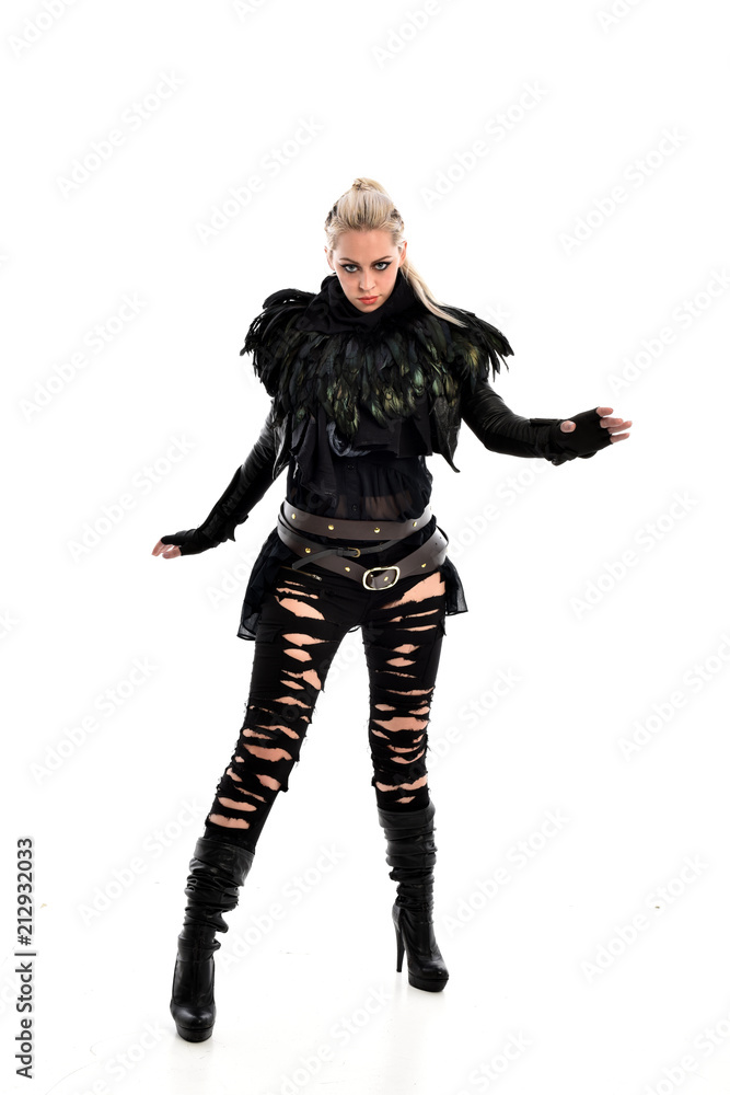 full length portrait of blonde girl wearing torn black feather costume. standing pose, isolated on white background. full length portrait of blonde girl wearing torn black feather costume. standing pose, isolated on white background.