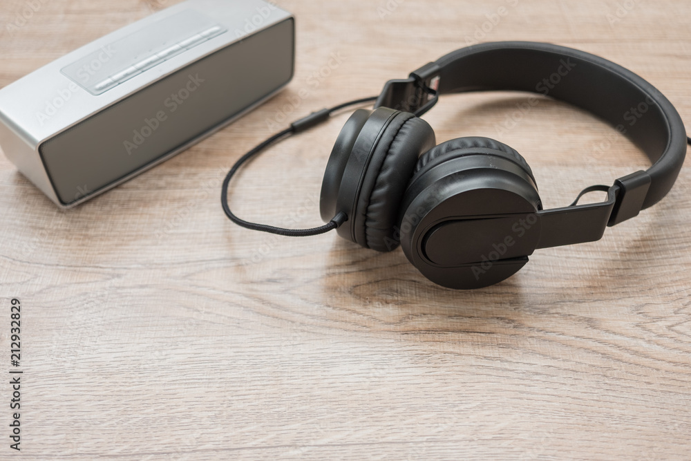 Black headphone,and music player put on wooden foor. Black headphone,and music player put on wooden foor.