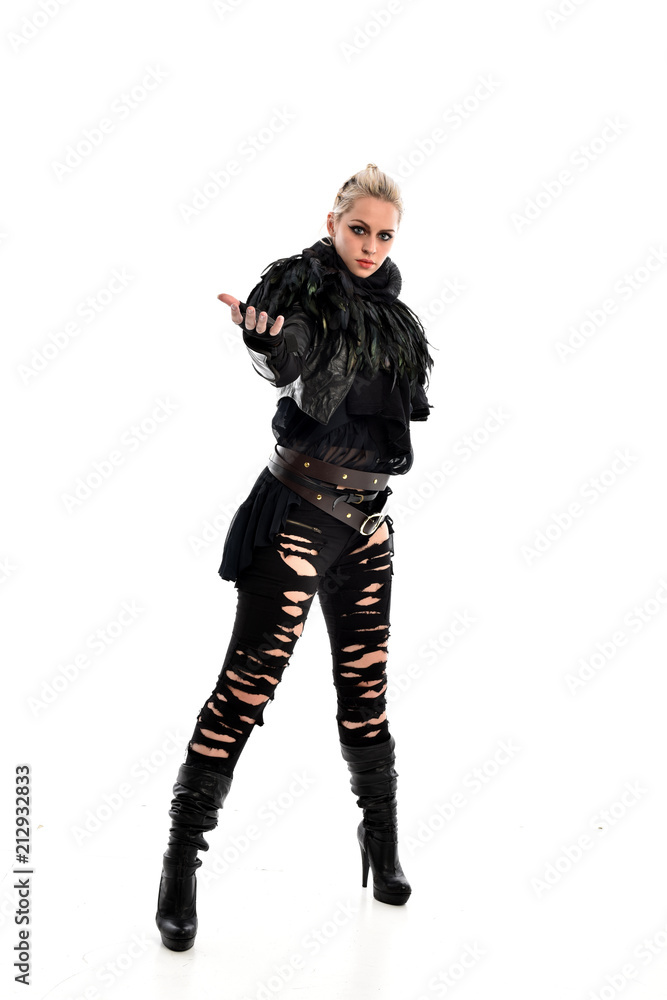 full length portrait of blonde girl wearing torn black feather costume. standing pose, isolated on white background.