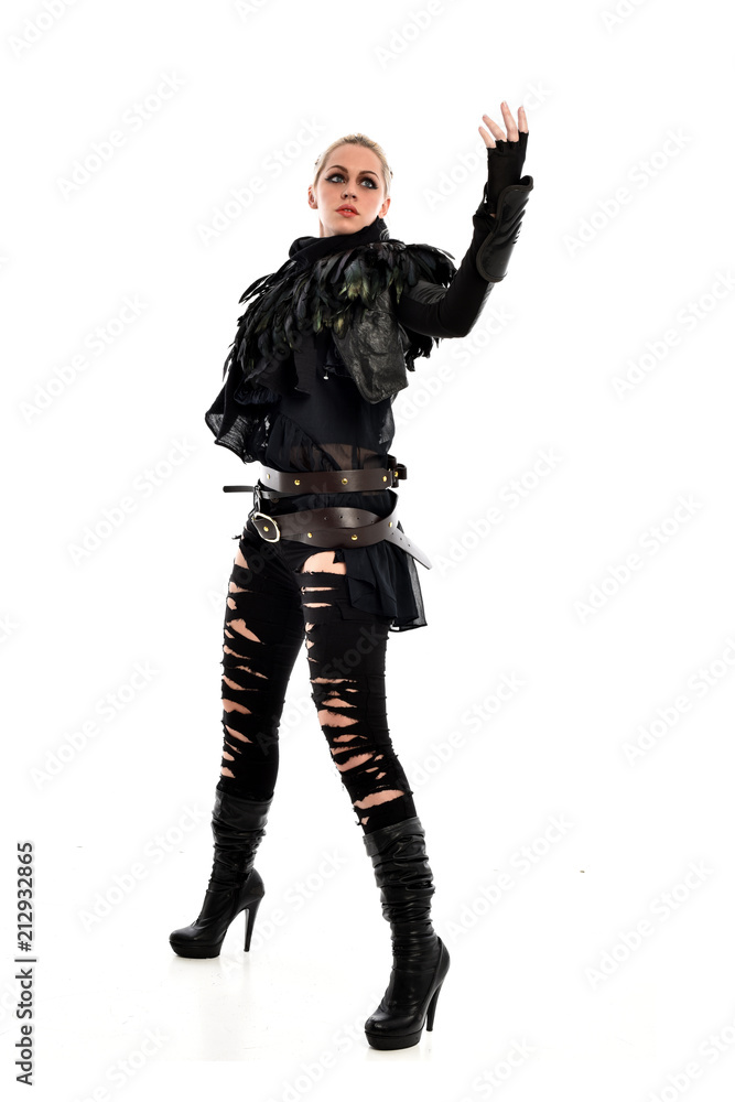 full length portrait of blonde girl wearing torn black feather costume. standing pose, isolated on white background. full length portrait of blonde girl wearing torn black feather costume. standing pose, isolated on white background.