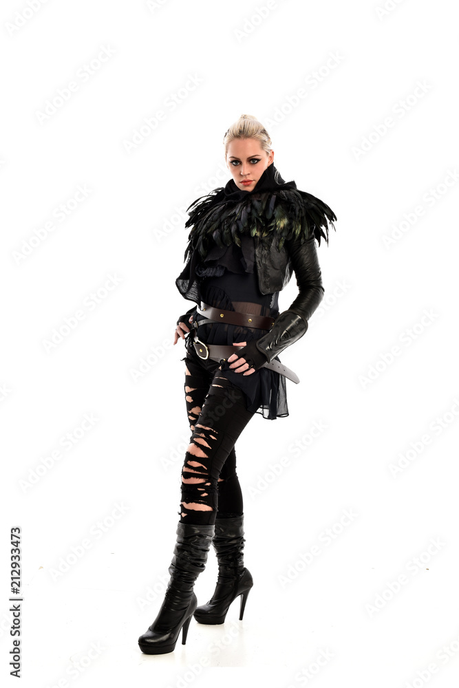 full length portrait of blonde girl wearing torn black feather costume. standing pose, isolated on white background. full length portrait of blonde girl wearing torn black feather costume. standing pose, isolated on white background.