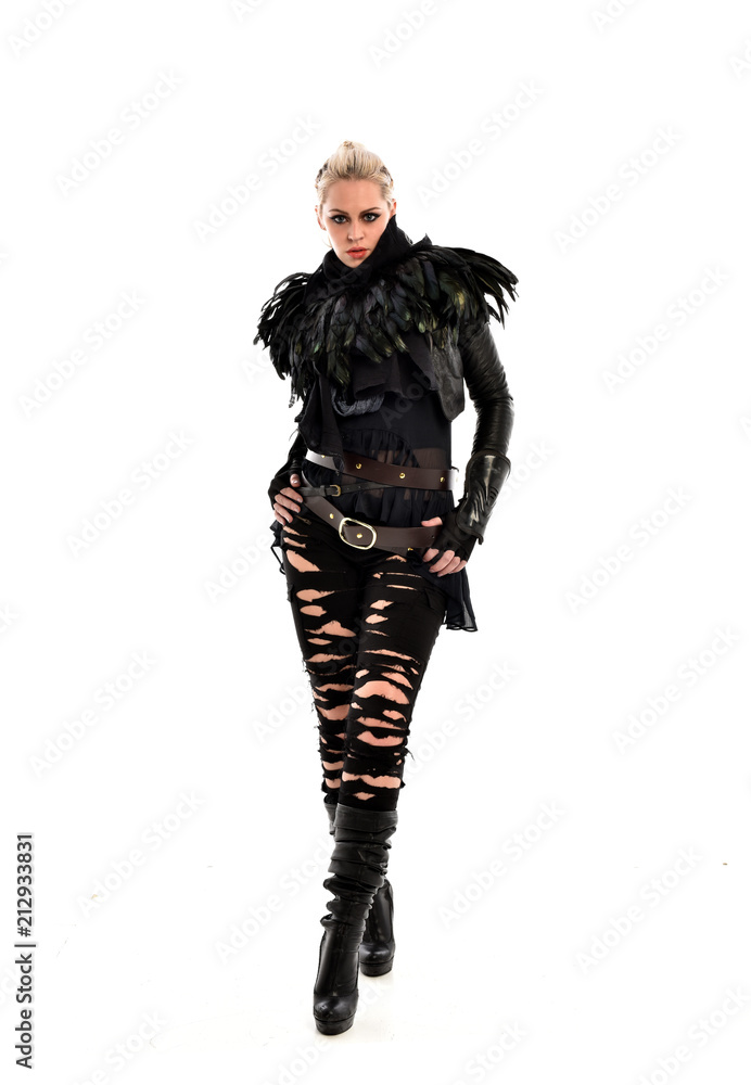 full length portrait of blonde girl wearing torn black feather costume. standing pose, isolated on white background. full length portrait of blonde girl wearing torn black feather costume. standing pose, isolated on white background.