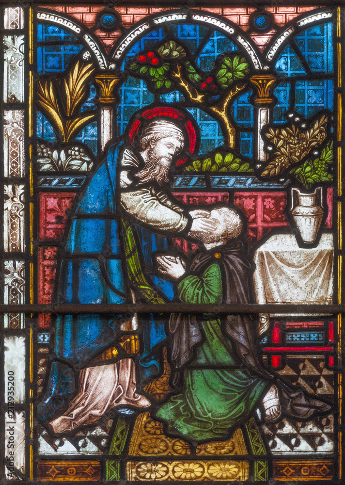 LONDON, GREAT BRITAIN - SEPTEMBER 19, 2017: The Ananias restoring sight to Saul  on the stained glass in St Mary Abbot's church on Kensington High Street.