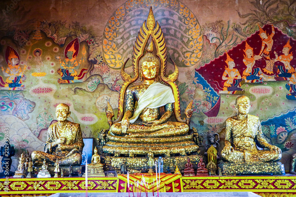 Big Gold buddha and gold monk status in buddhist temple and history thai art background