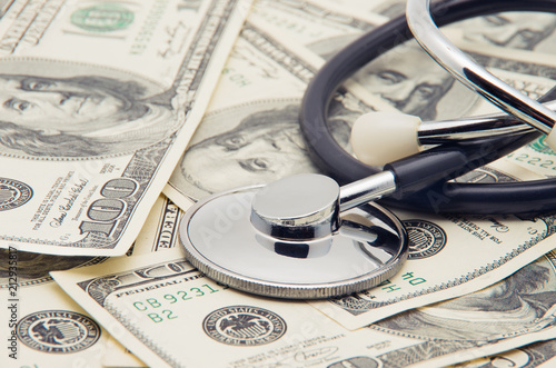 heap of dollars with stethoscope photo