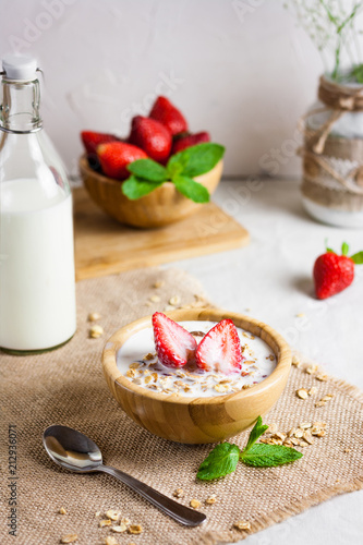 Homemade granola with fresh milk and strawberries for healthy breakfast