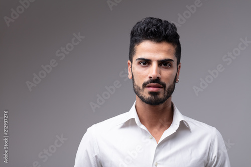 Young bearded man wearing white shirt