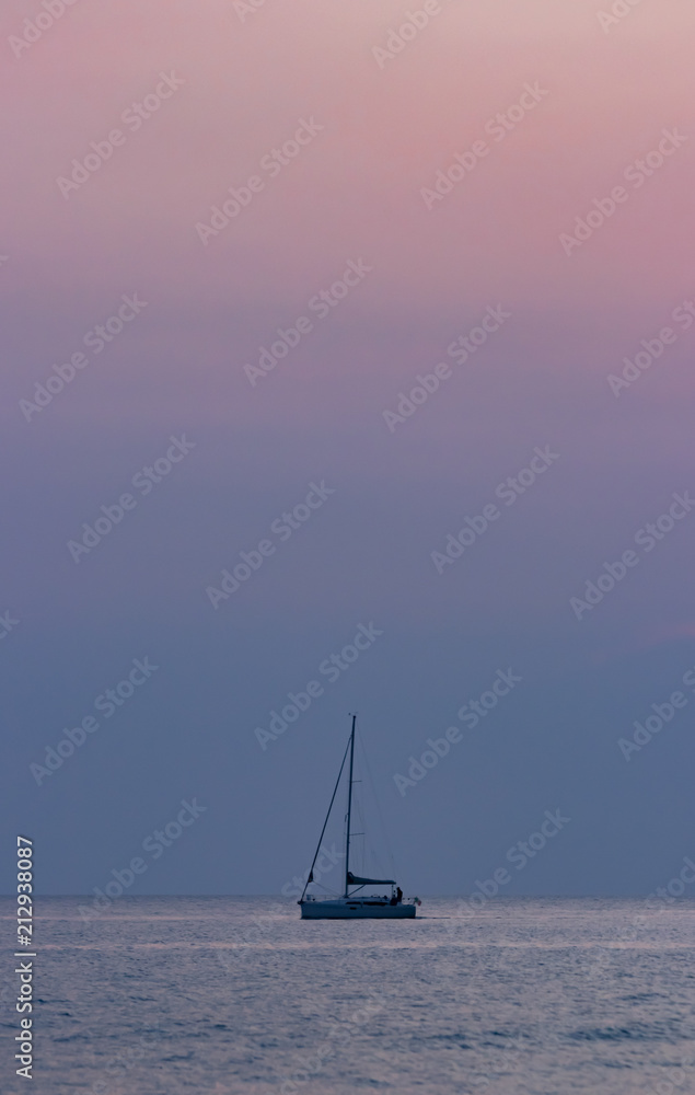 sailboat pierced through the silence of the sunset