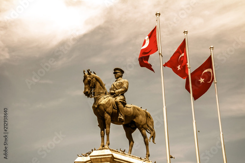 The statue of Ataturk and national flags of modern Turkey in Ulus - Ankara, Turkey photo
