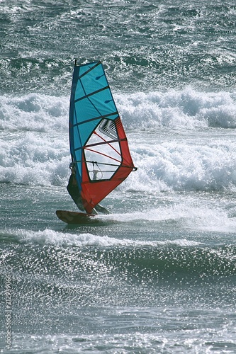 Windsurfing at the Atlantic ocean among breaking waves