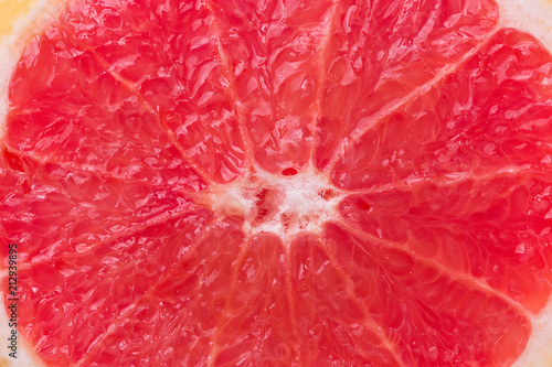 Macro Shot of Slice of Ripe Juicy Red Grapefruit Texture. Vitamins Healthy Diet Summer Detox Vegan Superfoods Concept. Food Background Poster Banner Template. Copy Space