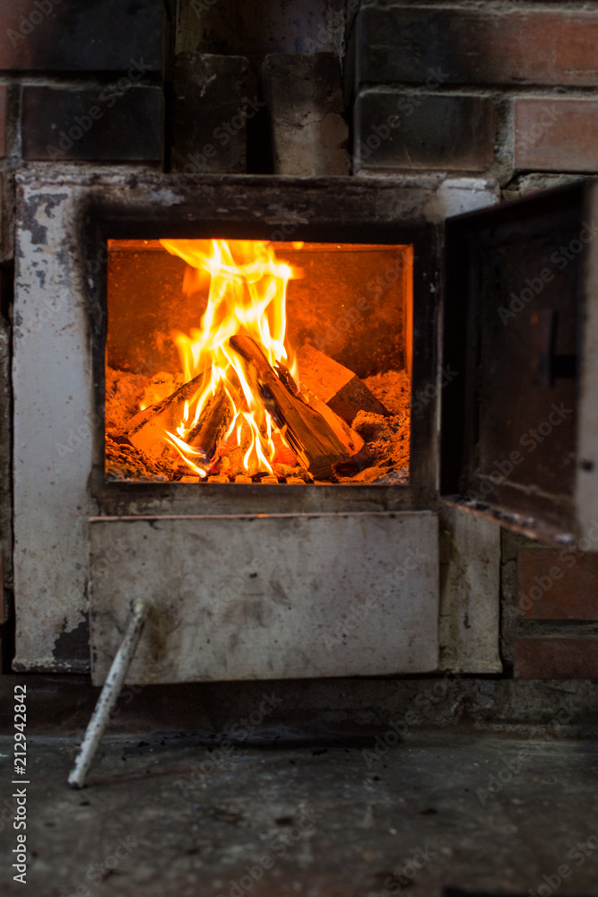 Bright red fire burns in the oven Bright red fire burns in the oven