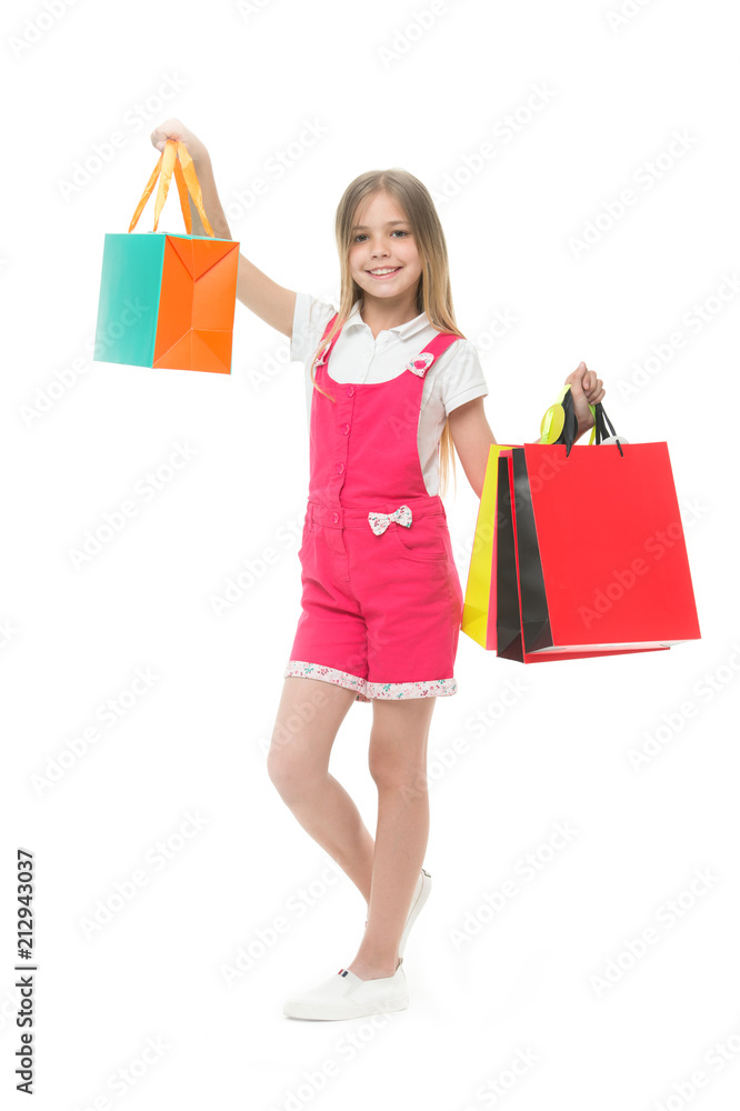 Girl shopper smile with bags isolated on white. Happy child hold shopping bags. Little shopaholic smiling with presents. Time for gifts. Shopping and sale Girl shopper smile with bags isolated on white. Happy child hold shopping bags. Little shopaholic smiling with presents. Time for gifts. Shopping and sale