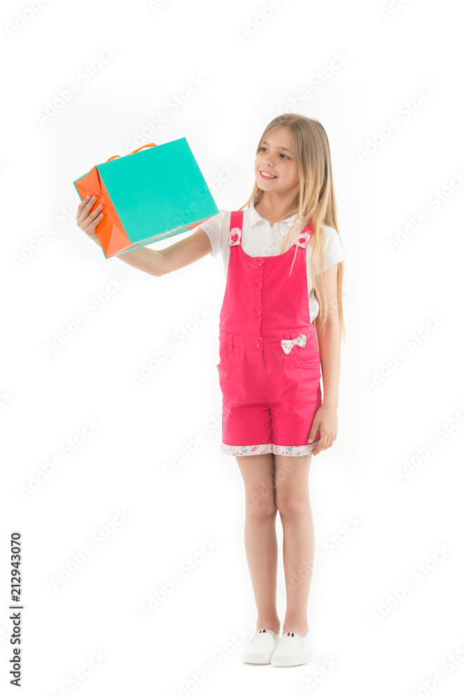 Little shopaholic smile with shopping bag isolated on white. Happy girl look at paperbag. Child shopper smiling with paper bag. Shopping and sale. This is a good choice, copy space Little shopaholic smile with shopping bag isolated on white. Happy girl look at paperbag. Child shopper smiling with paper bag. Shopping and sale. This is a good choice, copy space