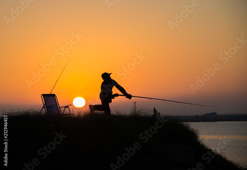 Man fishing at sunrise