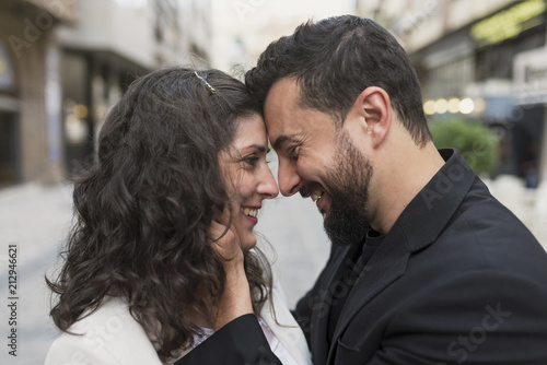 30s couple in the street in love hug