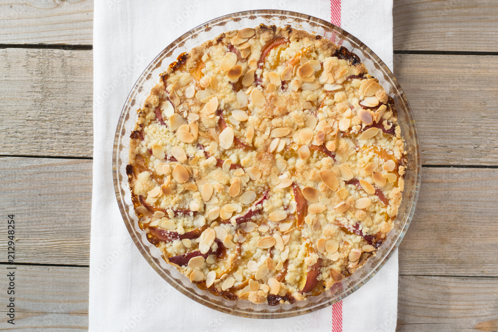 Peach crumble on a wooden and textile background