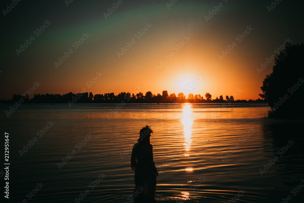 Silhouette girl against the backdrop of Sunrise