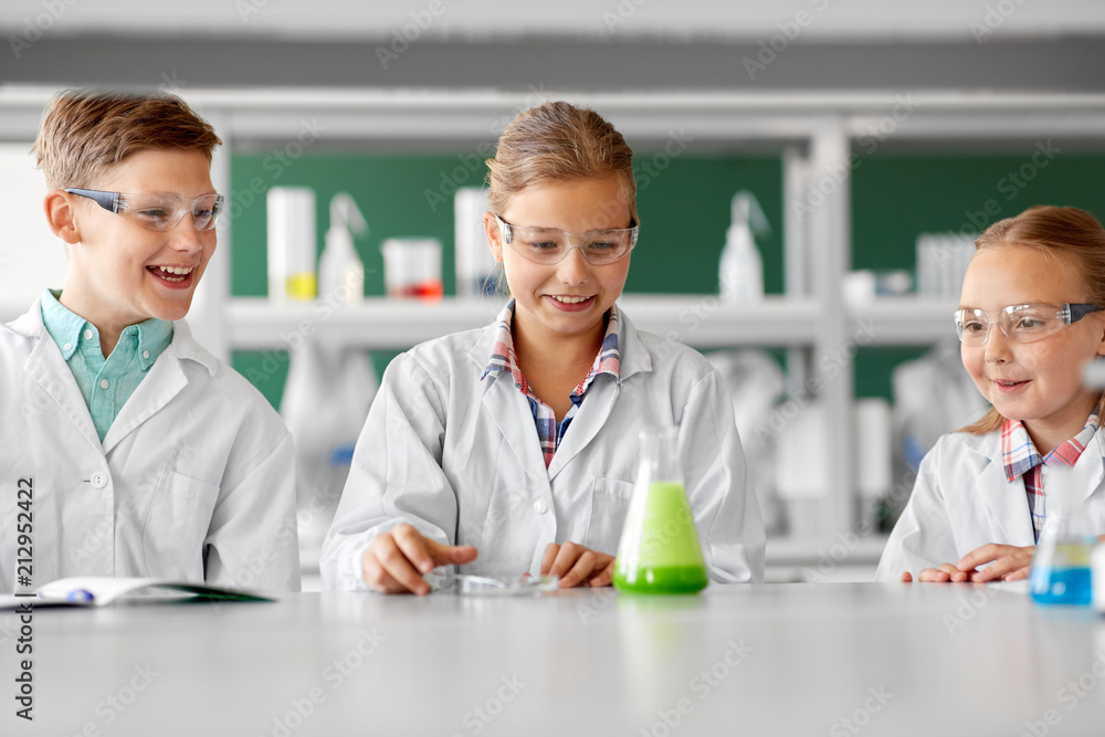education, science, chemistry and children concept - kids or students with test tube making experiment at school laboratory education, science, chemistry and children concept - kids or students with test tube making experiment at school laboratory