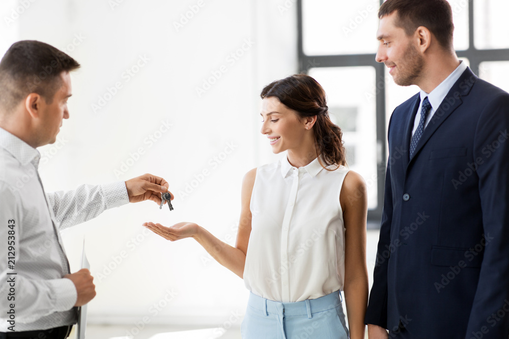 real estate business, sale and people concept - realtor giving key to customers or new office owner real estate business, sale and people concept - realtor giving key to customers or new office owner