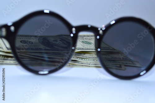 100 dollar bills through the sun goggles