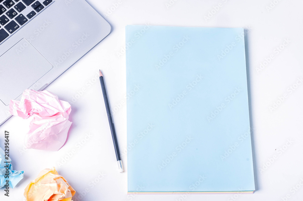 laptop sheets of paper, crumpled sheets of paper on a white background top view laptop sheets of paper, crumpled sheets of paper on a white background top view