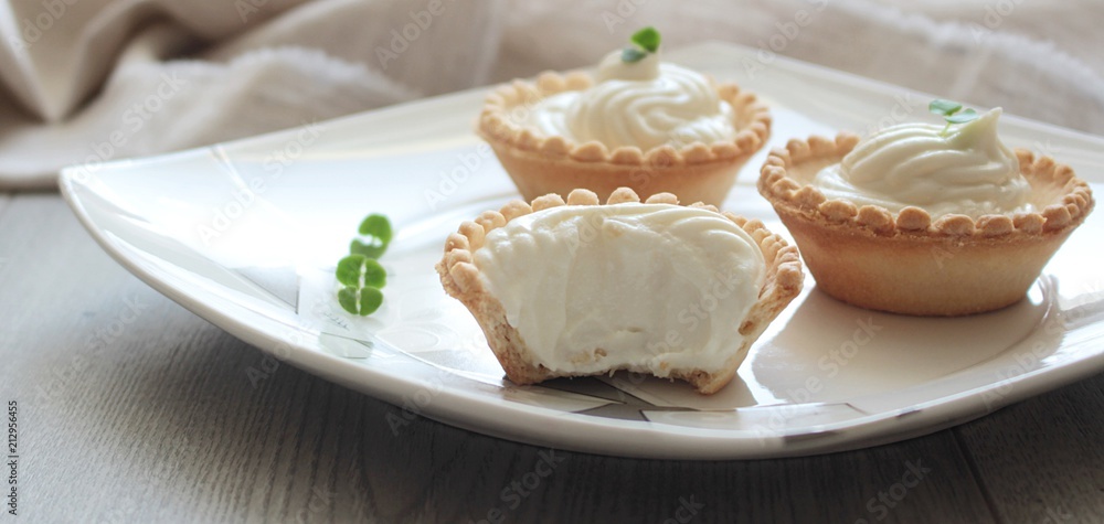 Antipasti tartlets with gentle cheese mousse served with herbs on wooden grey texture background with textile. Antipasti tartlets with gentle cheese mousse served with herbs on wooden grey texture background with textile.