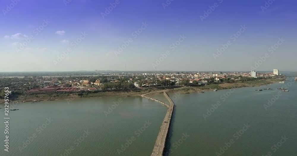 aerial drone shot : fly up revealing a long bamboo bridge connects to the Asia town aerial drone shot : fly up revealing a long bamboo bridge connects to the Asia town