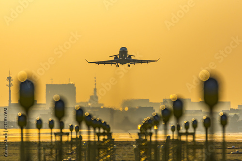 Business private jet takes off during golden hour