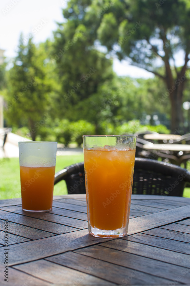 Two glasses with orange juice and ice Two glasses with orange juice and ice