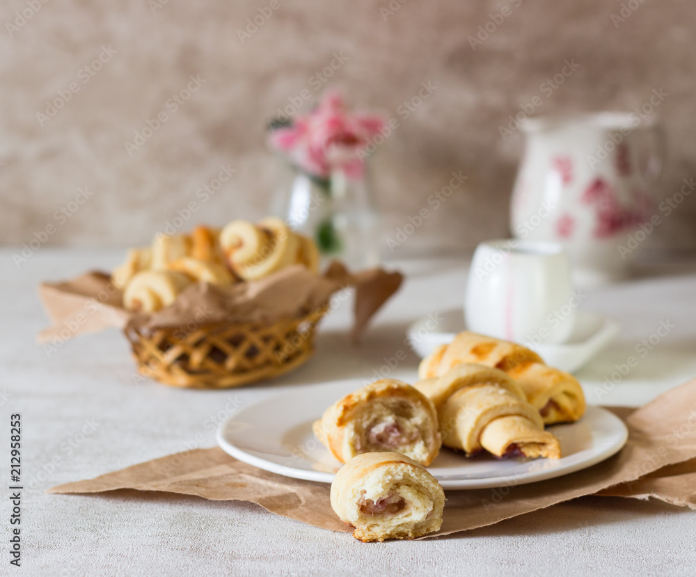 Fototapeta premium Red berry filling short crust pastry crescent rolls cookies. Jam rugelach (croissant), freshly baked sweet buns or bread rolls. Copy space for your text