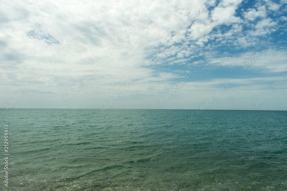 sea against a blue sky with clouds. landscape, leisure. resort. beautiful view of the summer sea.