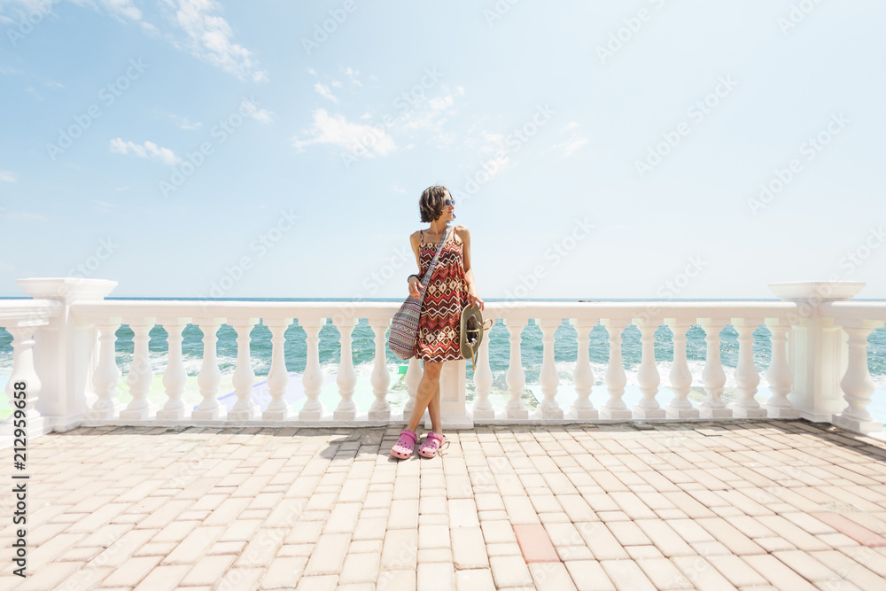 The girl is standing on the waterfront. The girl is standing on the waterfront.