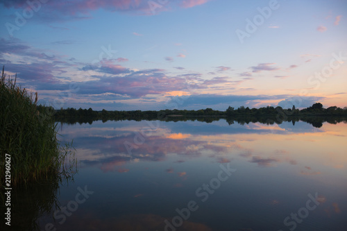 Landscape - calm fishing lake with sunset rteflection