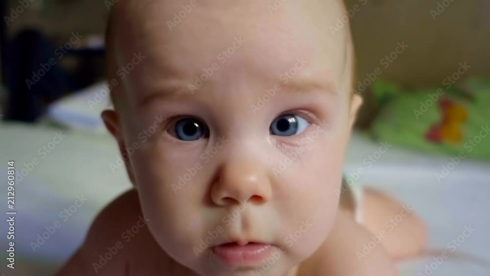 Close up. Portrait of a surprised baby with big blue eyes Close up. Portrait of a surprised baby with big blue eyes