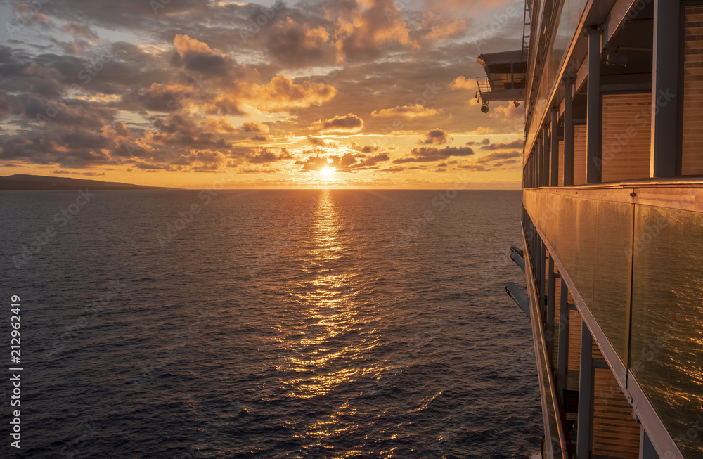 Cruise ship at sea with sun setting