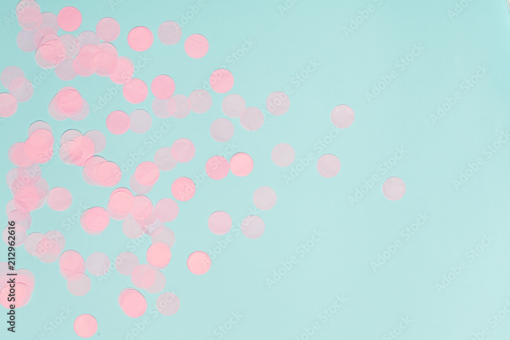 Pink confetti on blue background.