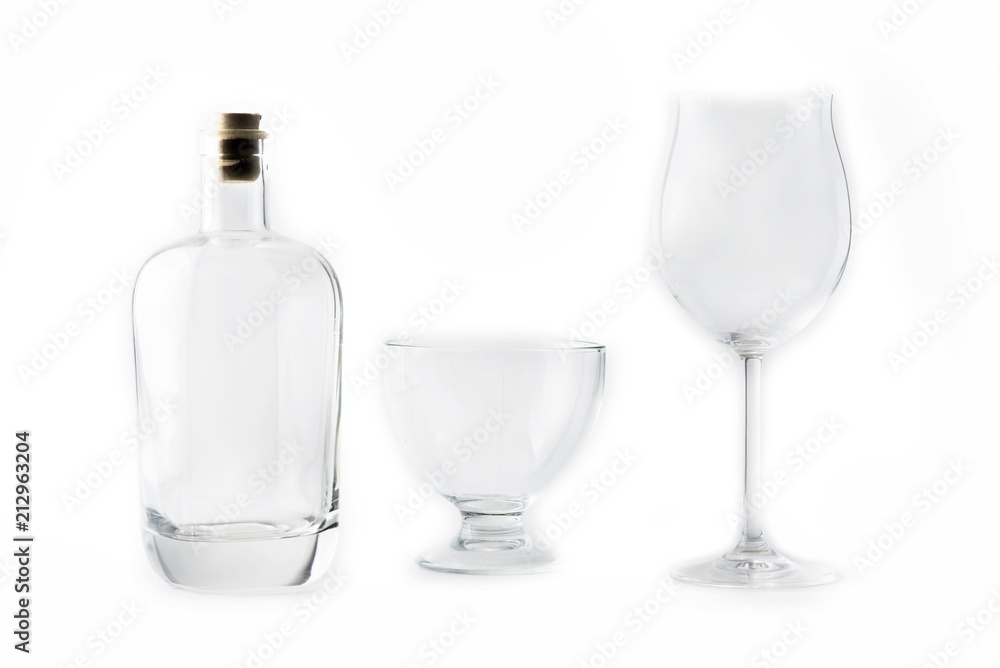 Empty transparent glass and bottle on the white Empty transparent glass and bottle on the white