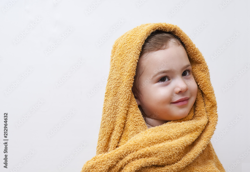 Obraz premium Cute happy smiling Baby Girl in soft Hooded Towel after Bath