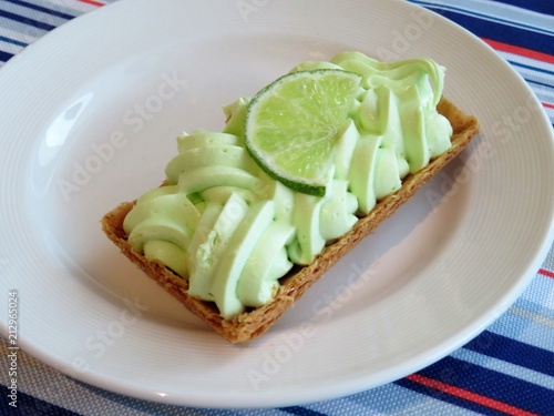 Fancy key lime pie dessert with a slice of lime