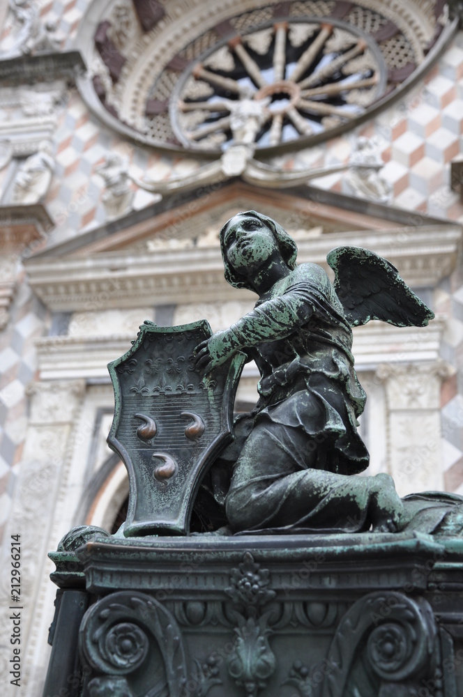 Angel sculpture on gate to cathedral in Bergamo