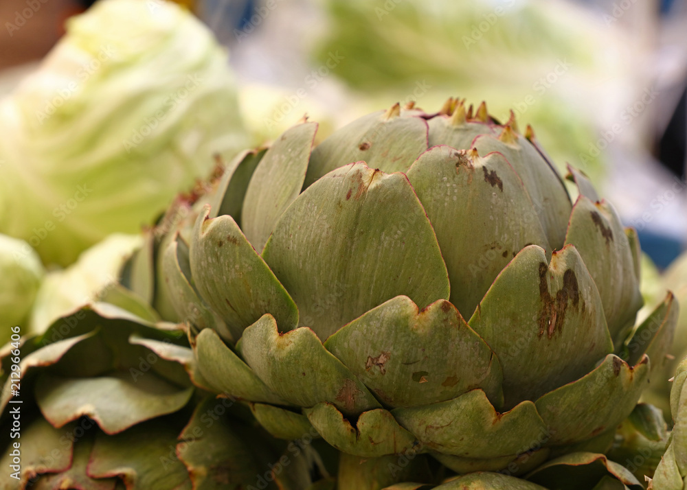 Green fresh globe artichokes on market stall Green fresh globe artichokes on market stall
