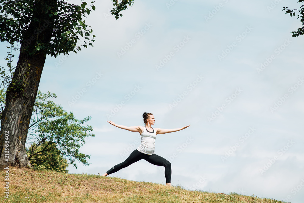 Young girl doing yoga in morning park.Woman Yoga - relax in nature Young girl doing yoga in morning park.Woman Yoga - relax in nature