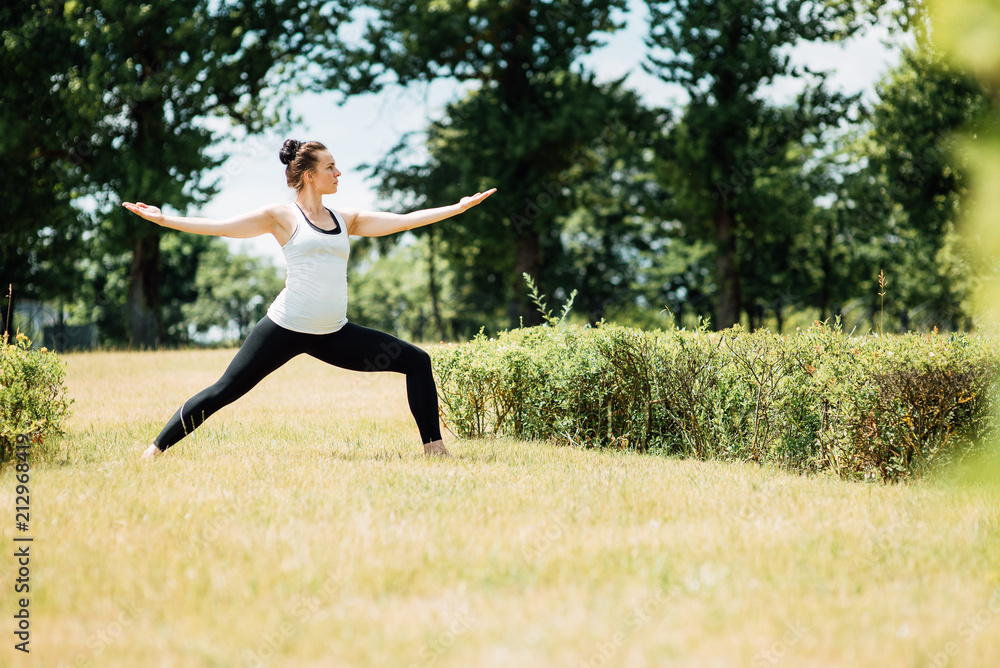 Young girl doing yoga in morning park.Woman Yoga - relax in nature Young girl doing yoga in morning park.Woman Yoga - relax in nature